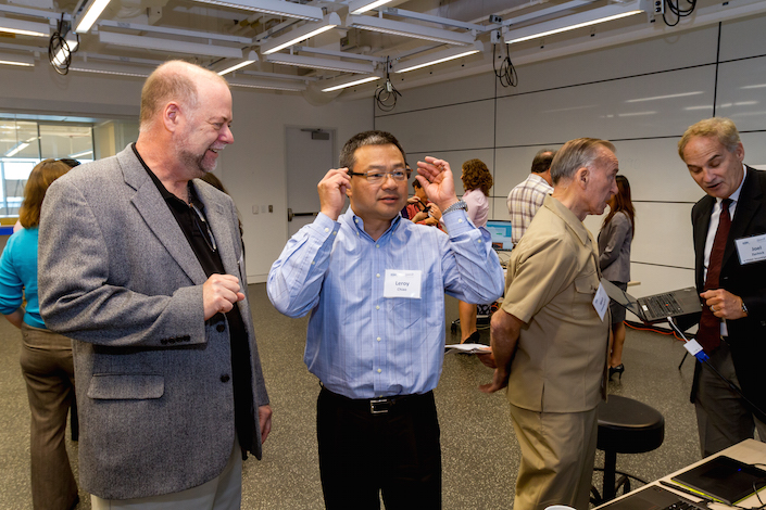 Commander Leroy Chiao, ret., tries on a pair of glasses with electronically adjustable lenses developed by eVision Smart Optics.